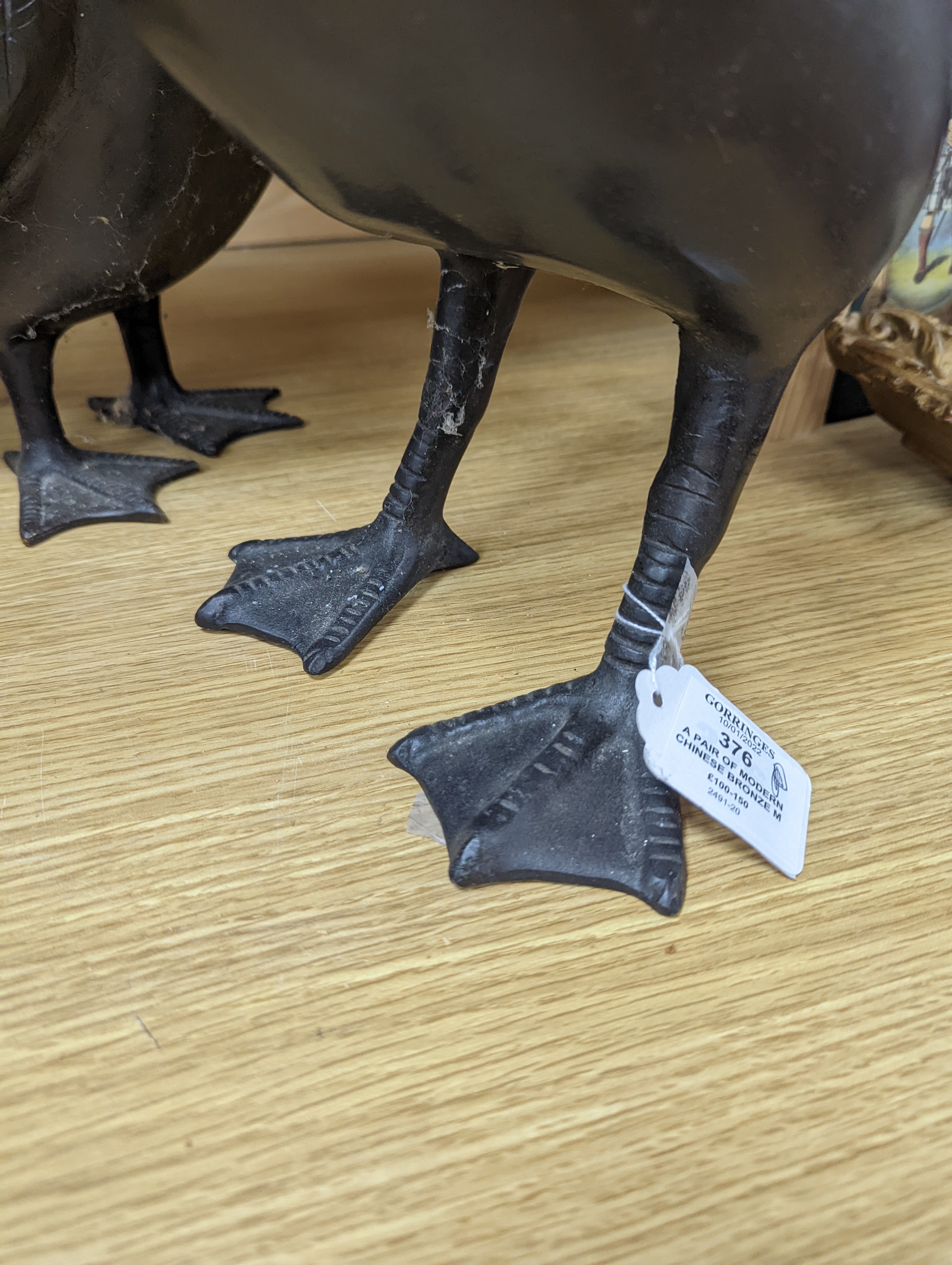 A pair of modern Chinese bronze models of geese, largest 48cm